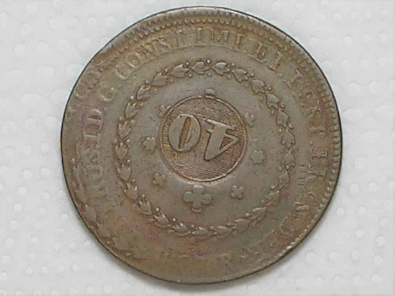 | Casa do Colecionador Recunho sobre outro 80 Réis) 80 Réis – 1827 Rio = 25 Tulipas / Florões Obliquos / Carimbo 40 / Recunho / Império D. Pedro I / Cobre / Mbc / Box24